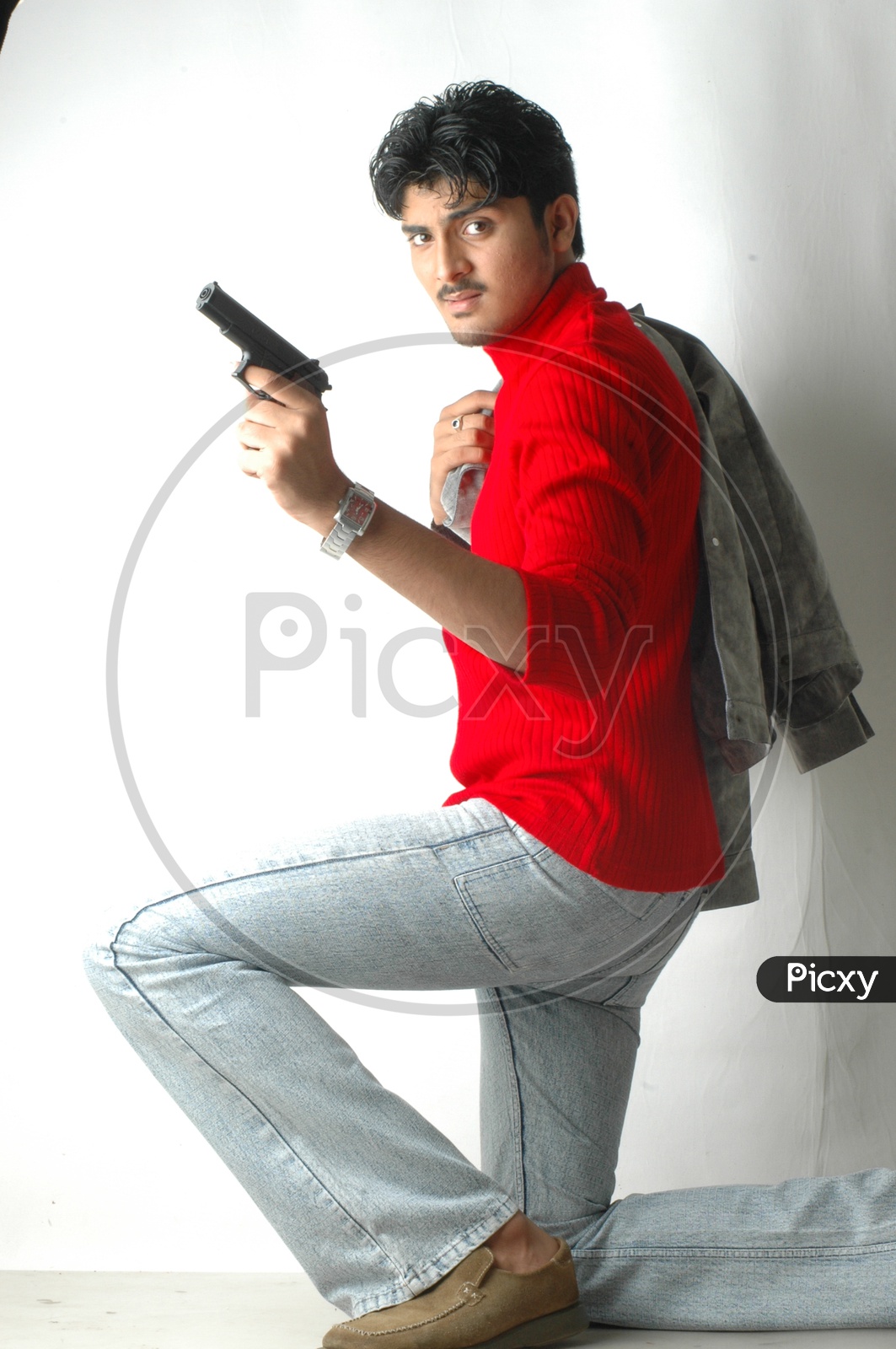 Black And White Portrait Of Young Bearded Man Posing With Gun In Hand Stock  Photo, Picture and Royalty Free Image. Image 148923185.