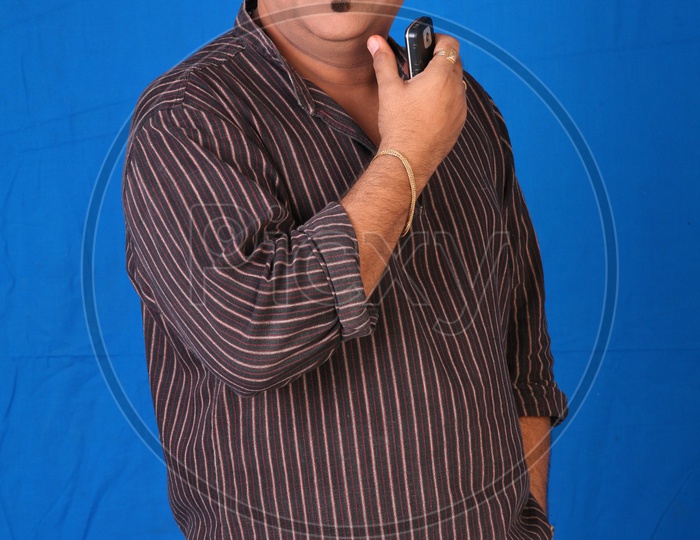 Portrait Of a Indian Man Or Tollywood Movie Character Artist In Casual Dress  On an Isolated Blue  Background