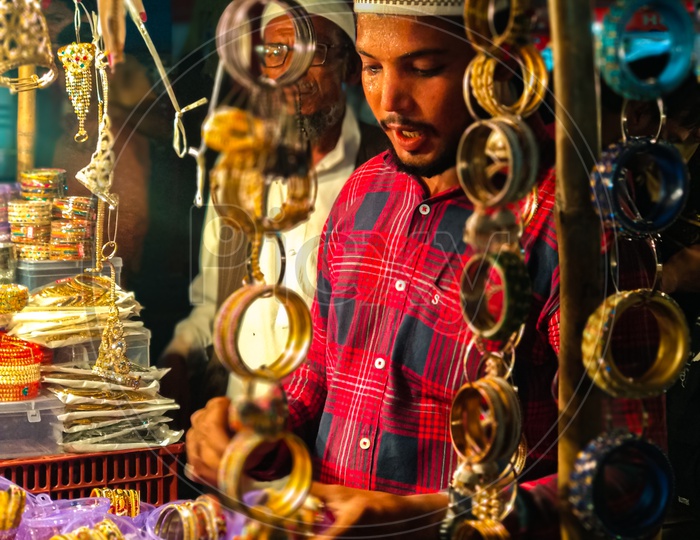 Bangles vendor getting sweat while selling bangles at 10PM from charminar shopping