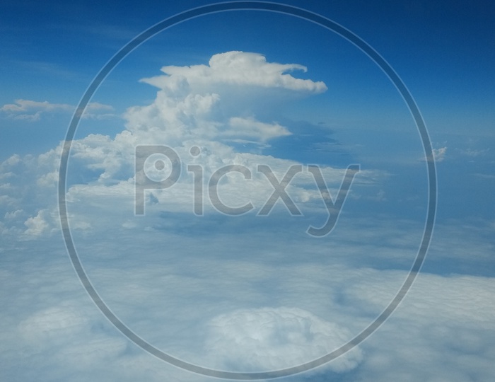 View Of Cotton Clouds And Blue Sky From Flight Window