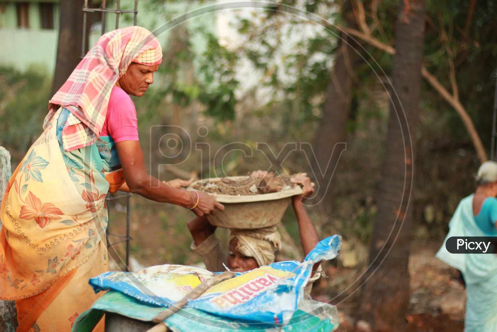 Indian Female Worker handling the Construction Ghamela