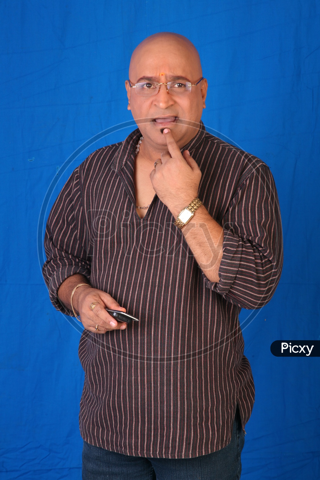 Portrait Of a Indian Man Or Tollywood Movie Character Artist In Casual Dress  On an Isolated Blue  Background