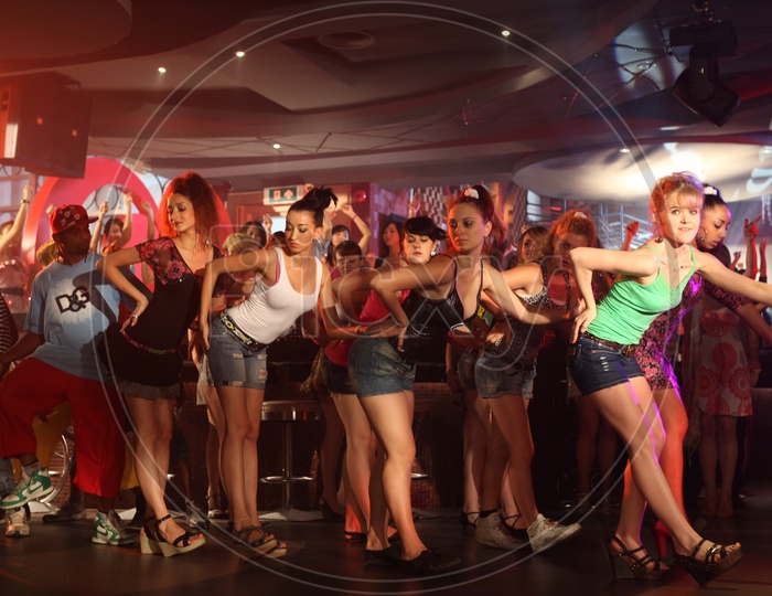 A Group Of Young Woman Dancers Dancing In A Pub