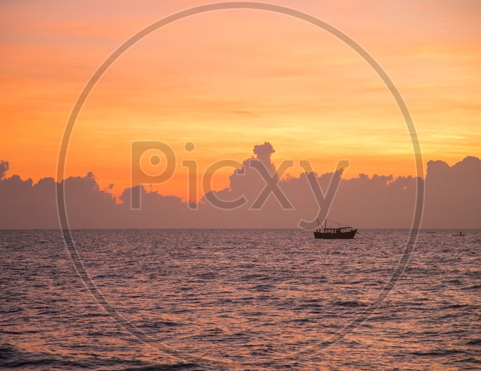 Boats during sunrise in Pondicherry Rock beach