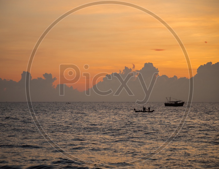 Boats during sunrise in Pondicherry Rock beach