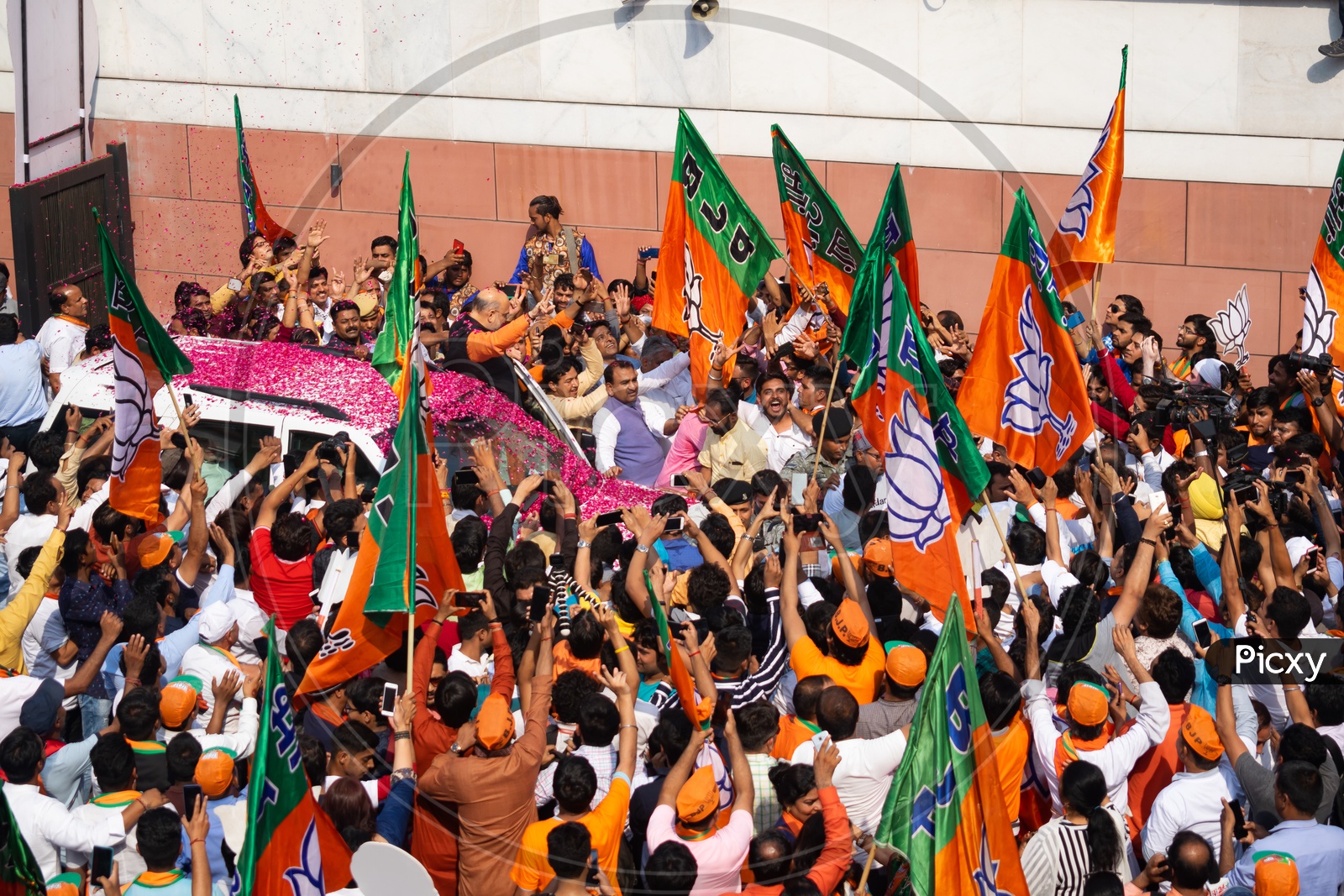 Flags of Bhartiya Janta Party (BJP) and people celebrating victory of the party