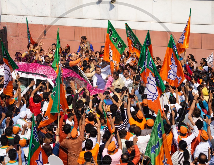 Flags of Bhartiya Janta Party (BJP) and people celebrating victory of the party