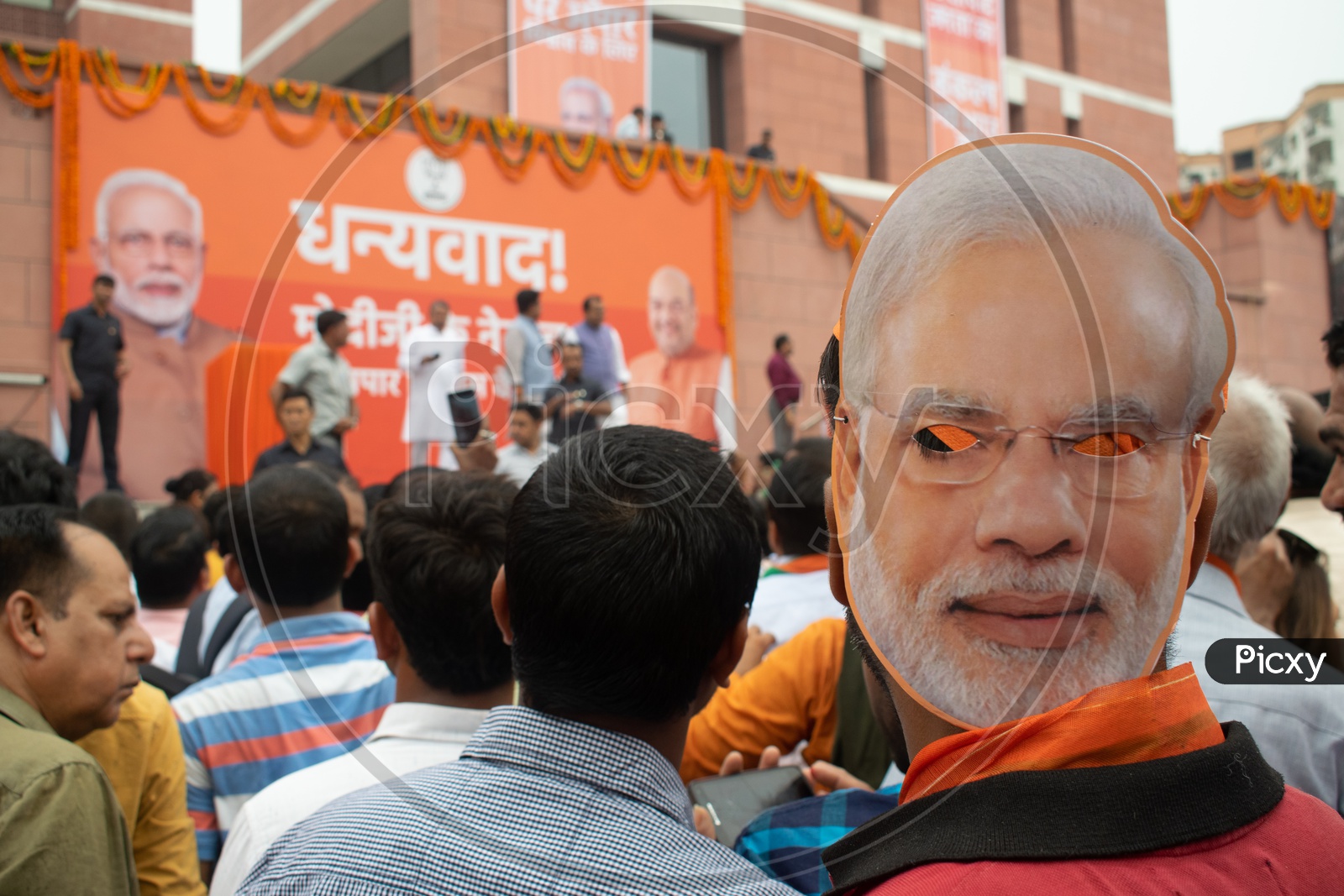 A man wearing mask of PM Narendra Modi during victory of Bhartiya Janta Party (BJP) in Lok Sabha election.