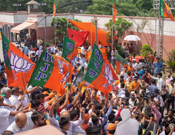 People holding Bhartiya Janta Party(BJP) flags