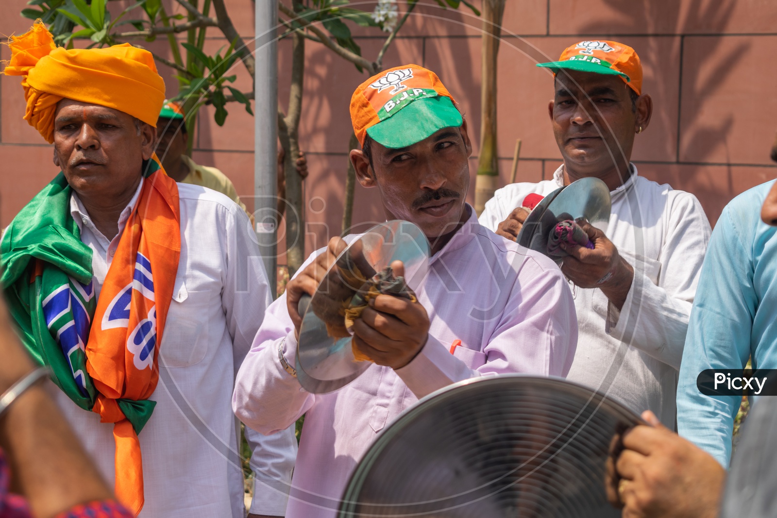 Men playing cymbals (Jhanj-manjira) at the occasion of Bhartiya Janta Party(BJP) victory