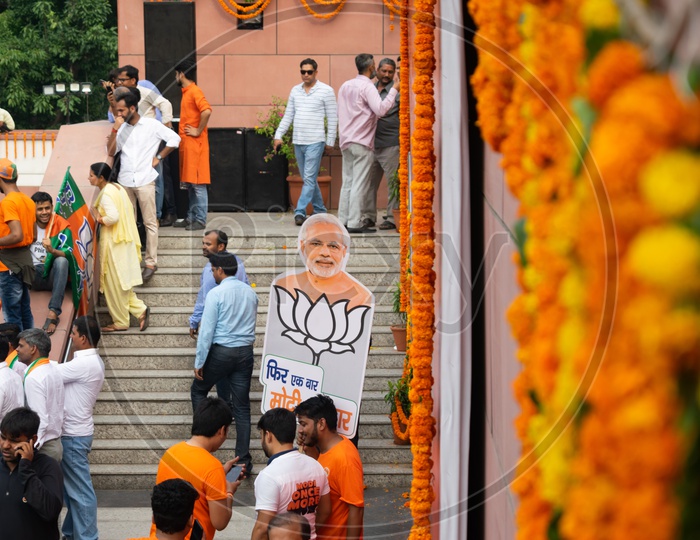 Bhartiya Janta Party (BJP) Head office decorated with flowers and man holding banner of Narendra Modi