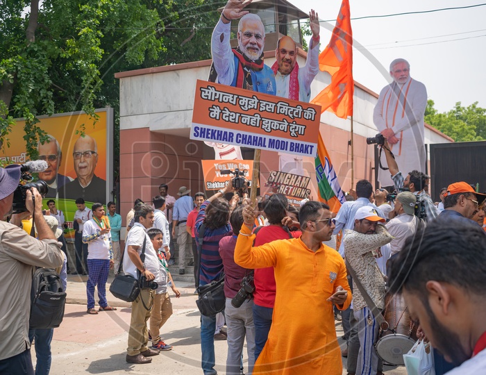 Supporters holding banners of Narendra Modi and Amit Shah and flags to support Bhartiya Janta Party(BJP)