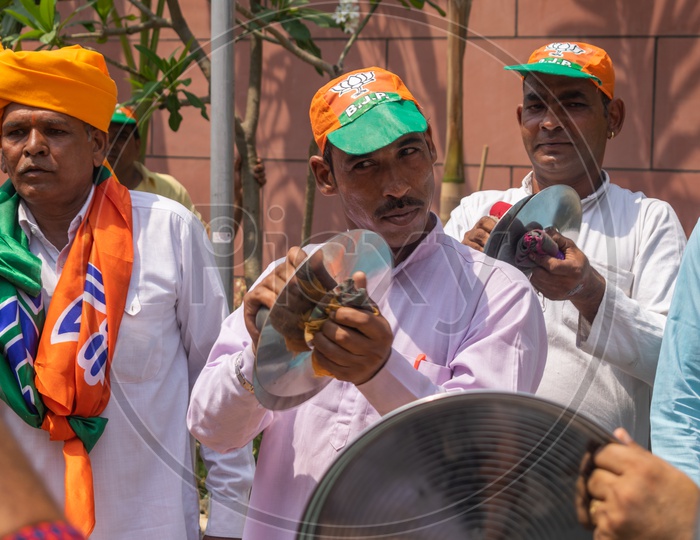 Men playing cymbals (Jhanj-manjira) at the occasion of Bhartiya Janta Party(BJP) victory