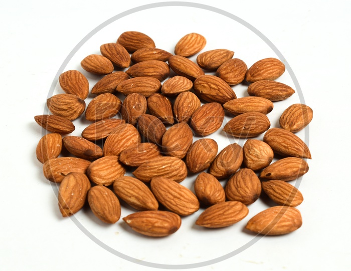 Almonds/ Badam pappu on a white background.