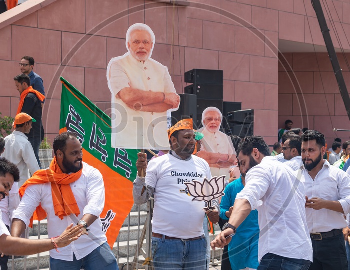 Men holding banners of Narendra Modi and sign of Bhartiya Janta Party(BJP)