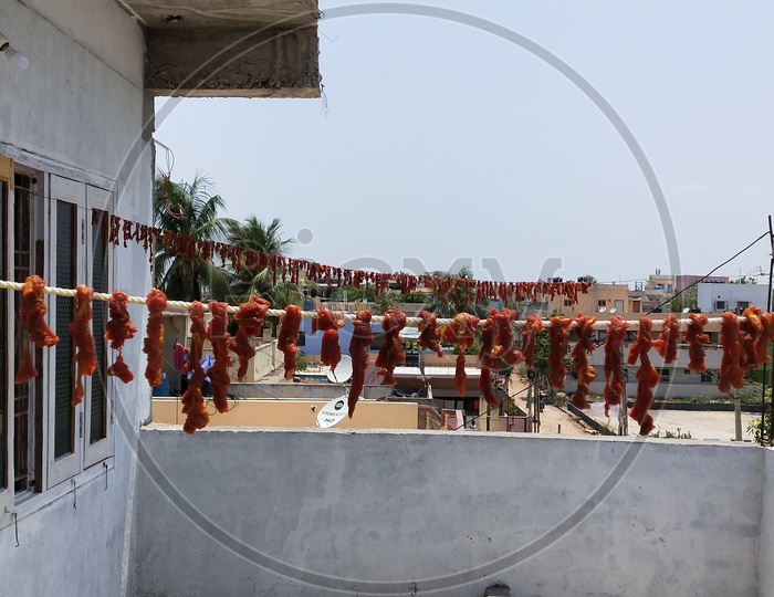 A picture of mutton pieces hanged in the hot summer