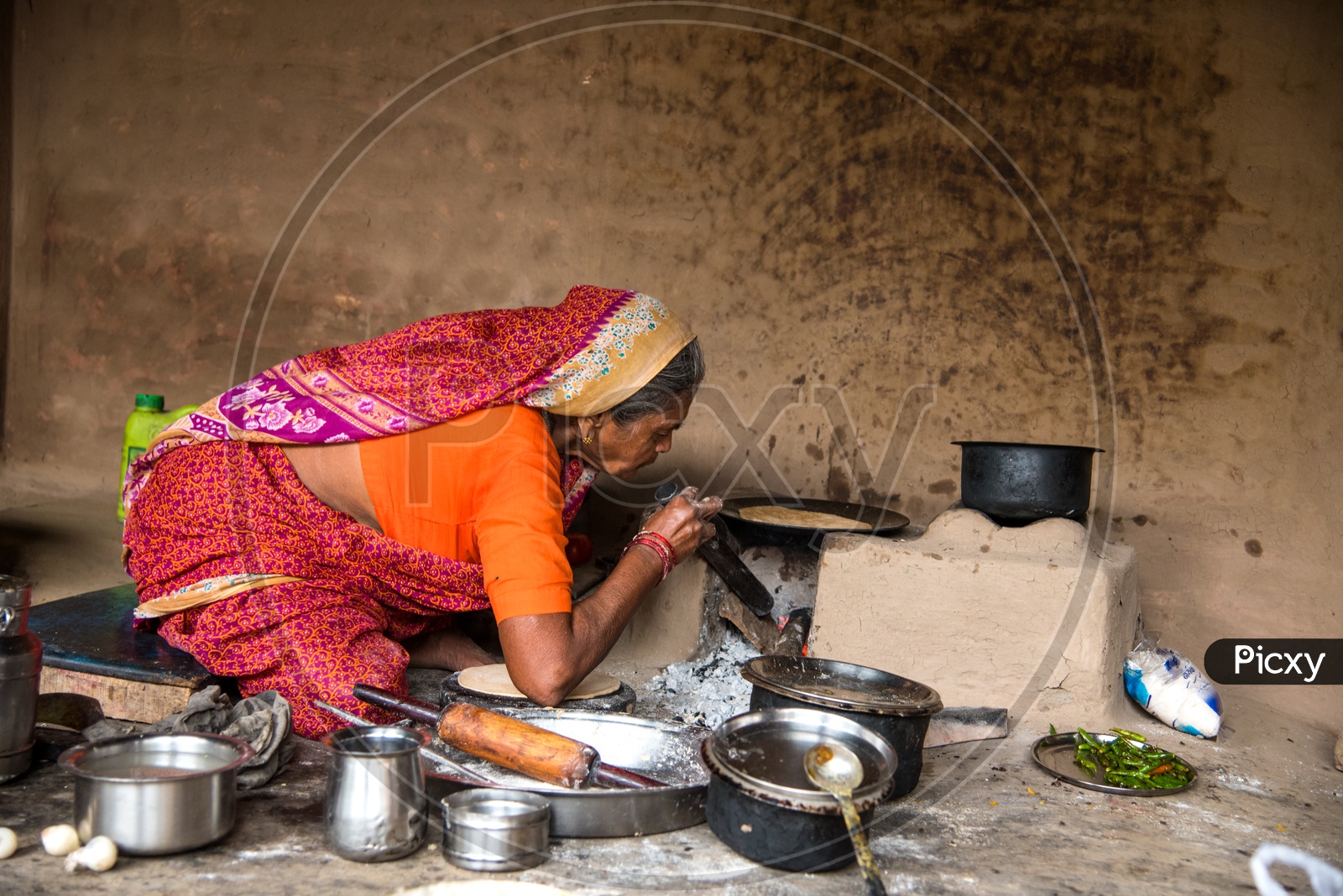 Image Of An Indian Old Woman Making Or Cooking Food In An Ancient Or 