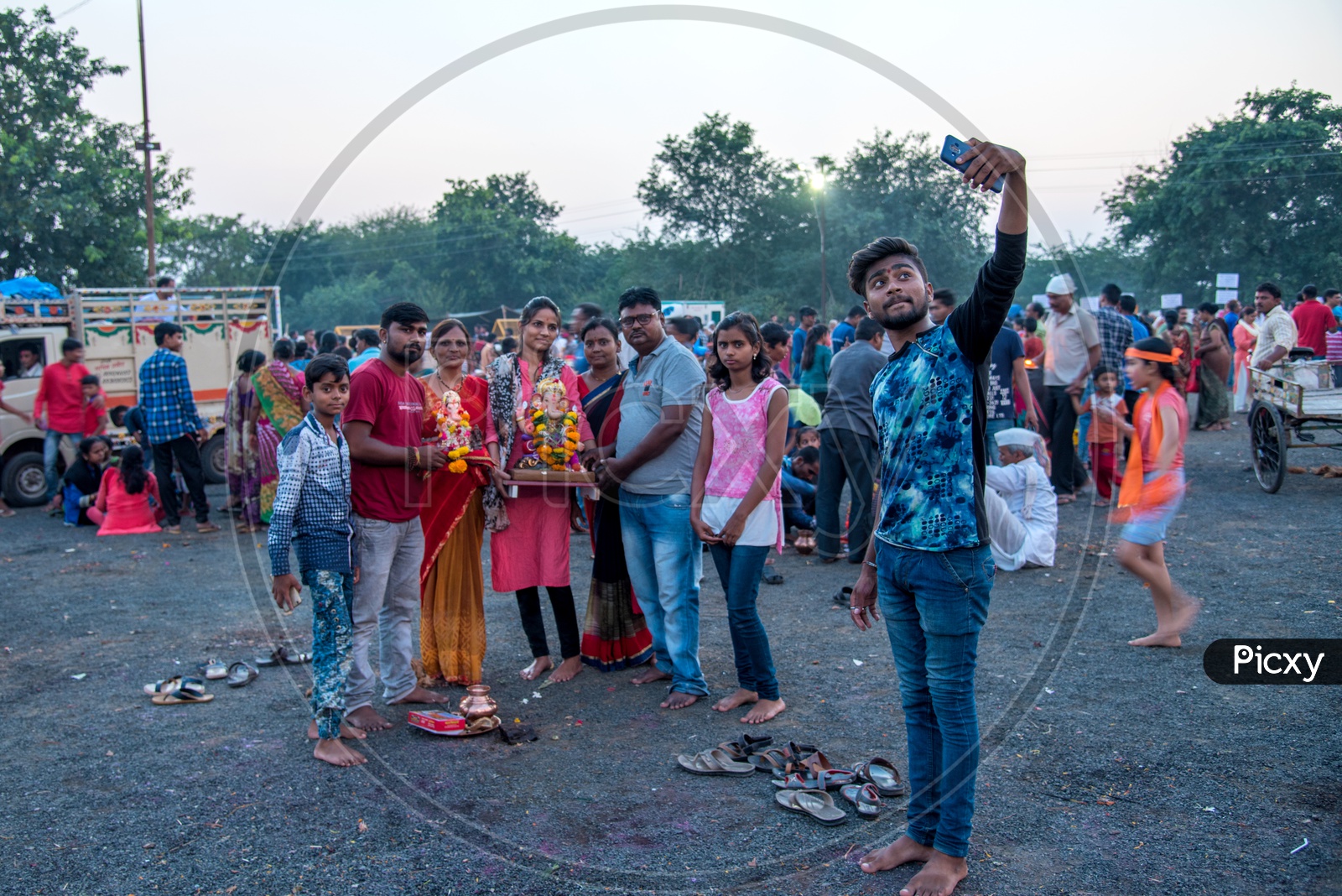 An Indian Devotees  Taking A Selfie In Smart Phone With Ganesh Idol During  Ganesh Visarjan Or  Nimarjan