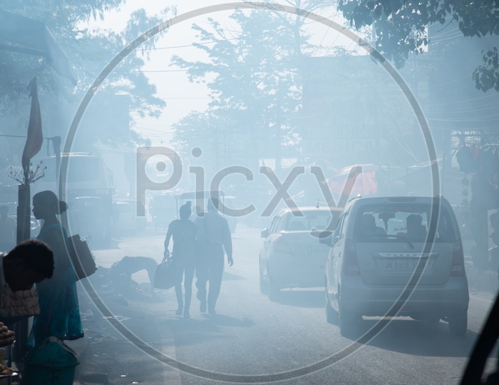 Pedestrians  Walking On The Smoke Filled Roads   in Indian Cities