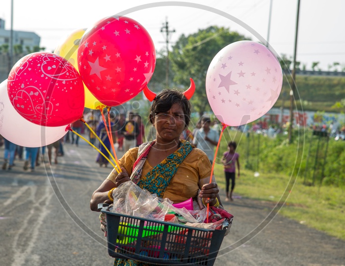 A Woman Street Vendor Of Dolls And Balloons   on Indian Streets