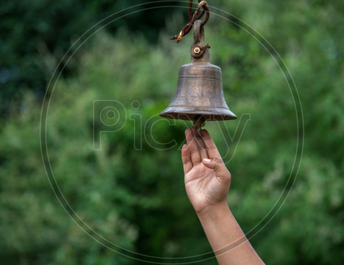 An Indian Devotee Ringing The Temple Brass Bell