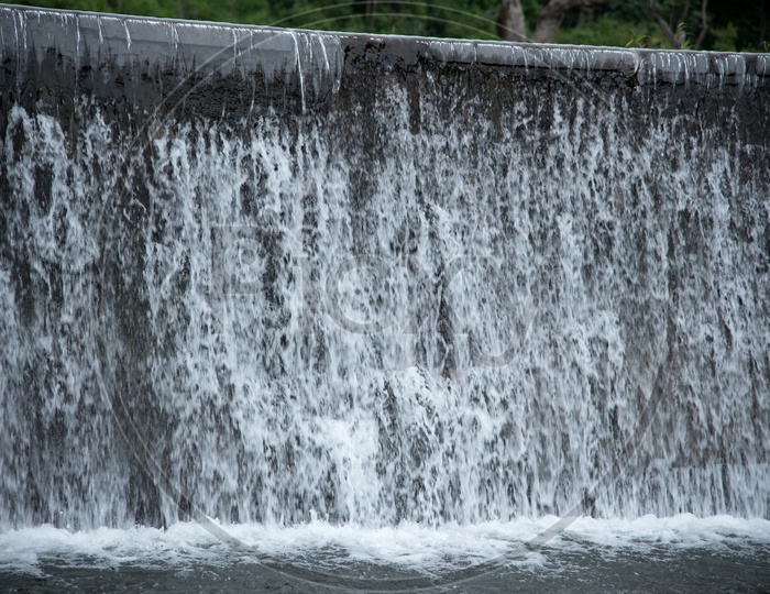 River Water Flowing Down from Check Dam Walls