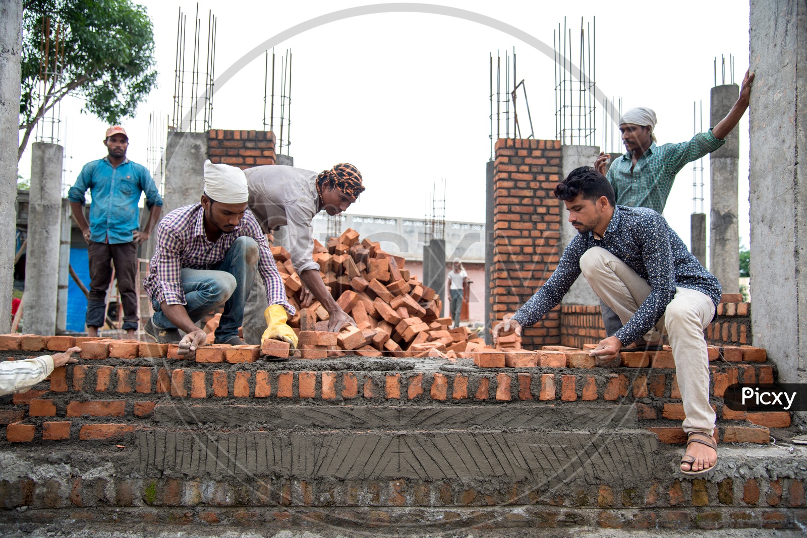 Image of indian rural construction workers working developing a site by