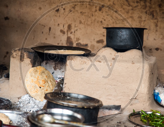 Cooking Food  in an Traditional  Earthen Stove  in an  Indian  Rural Village Kitchens