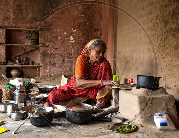 Image of An Indian Old Woman Making Or Cooking Food In an Ancient Or ...