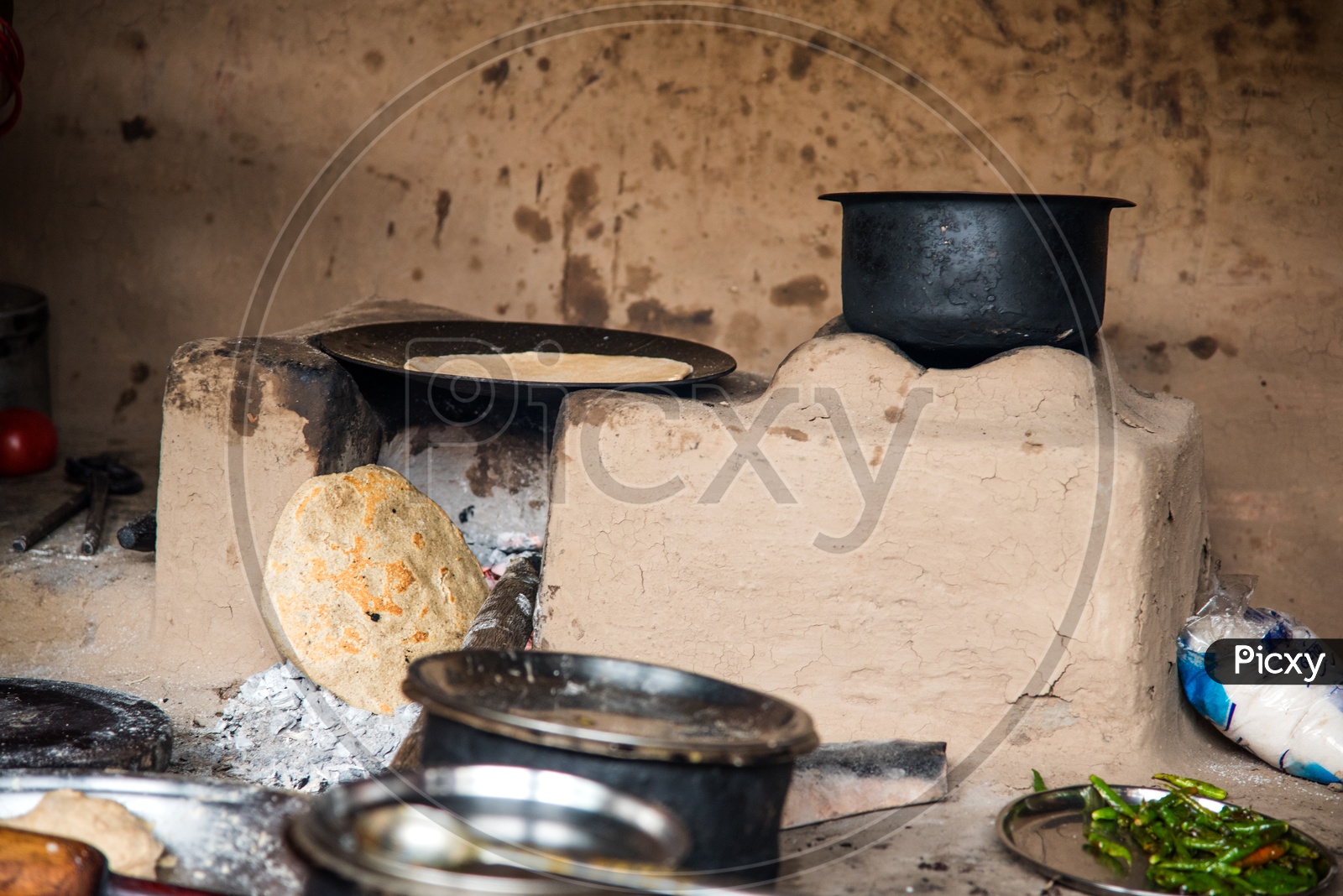 Cooking Food  in an Traditional  Earthen Stove  in an  Indian  Rural Village Kitchens