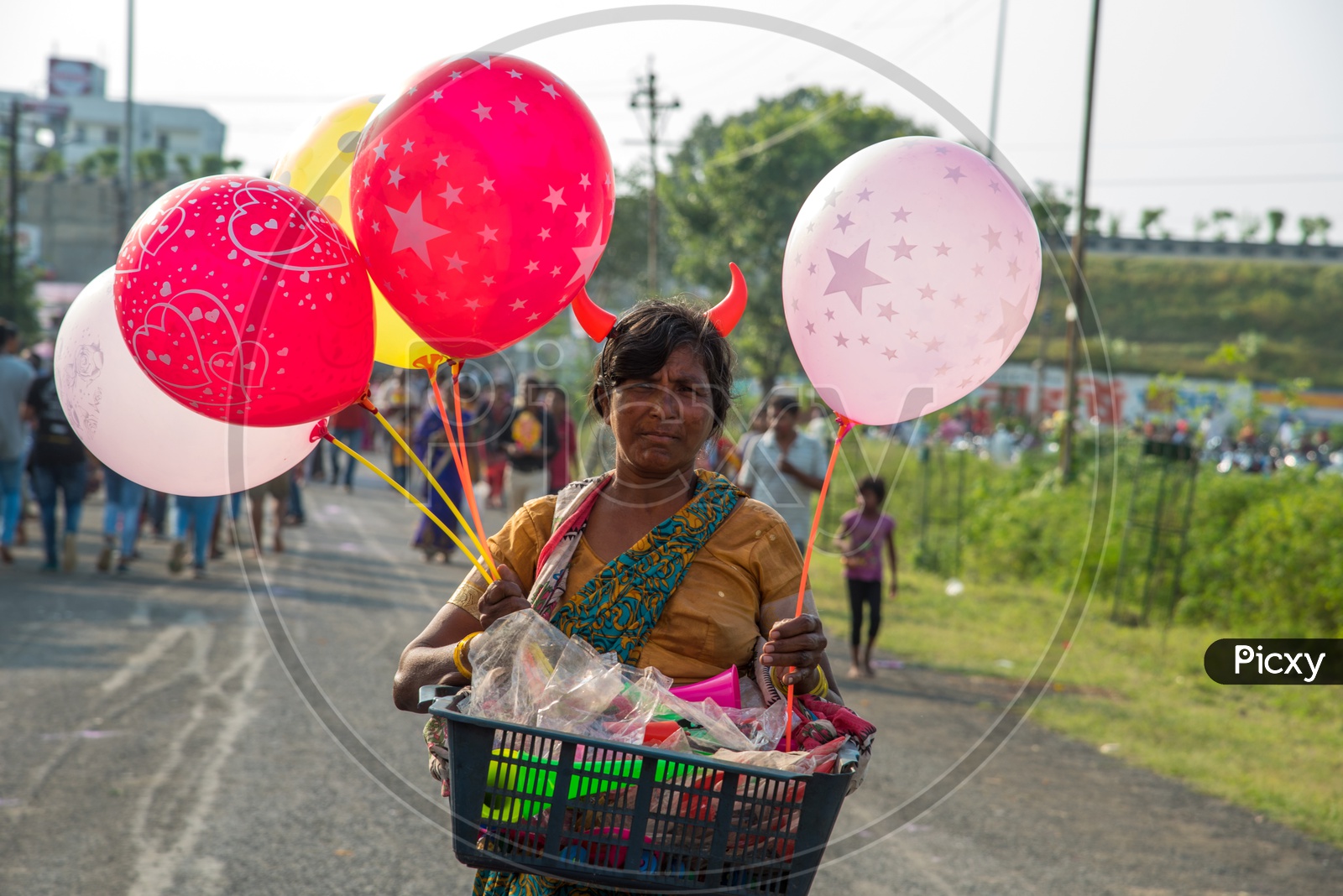 A Woman Street Vendor Of Dolls And Balloons   on Indian Streets