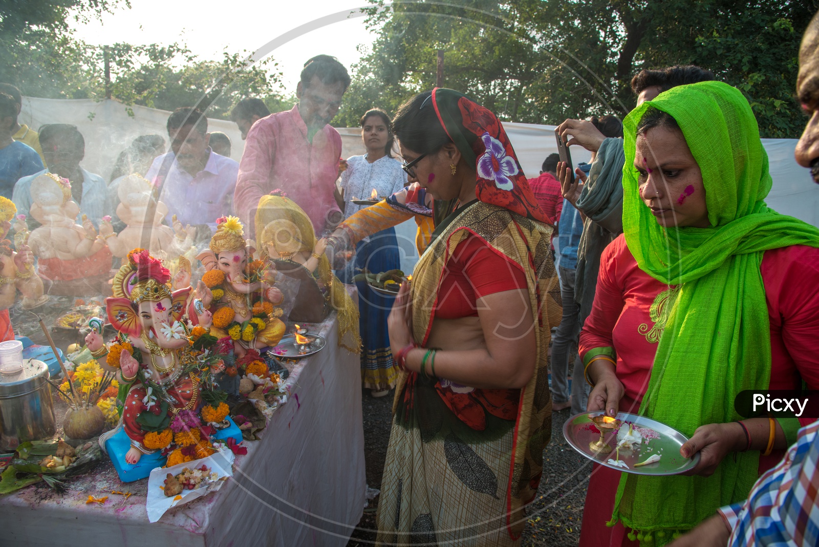 Indian Hindu Devotees Worshiping lord  Ganesh Idols  For The Last Time Before Visarjan Or Nimarjan  During The Ganesh Chathurdi Or Vinayaka Chaviti Festival