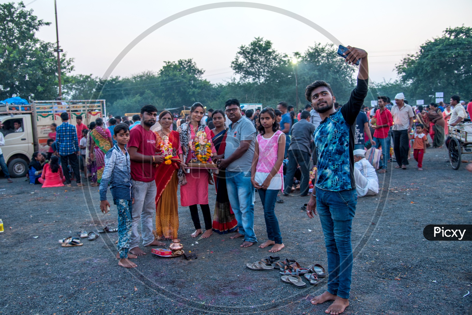 An Indian Devotees  Taking A Selfie In Smart Phone With Ganesh Idol During  Ganesh Visarjan Or  Nimarjan