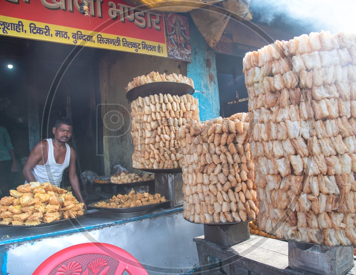 A Street Food Vendor Stall With Food Items  In Display