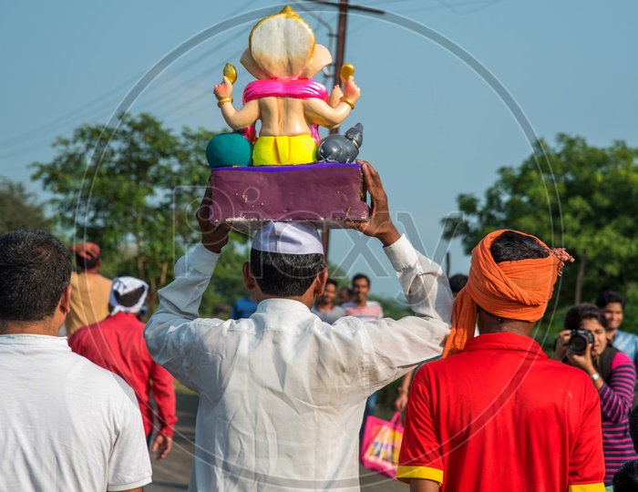 Indian Hindu Devotees  Carrying Lord Ganesh  Or Vinakaya   Idols  For  Visarjan  Or  Nimarjan  On The Occasion Of  Ganesh Festival Or Ganesh Chathurdhi  Festival