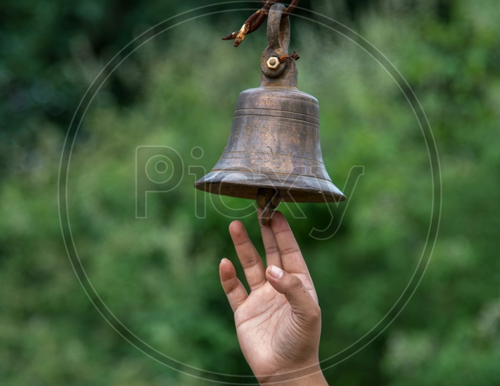 An Indian Devotee Ringing The Temple Brass Bell