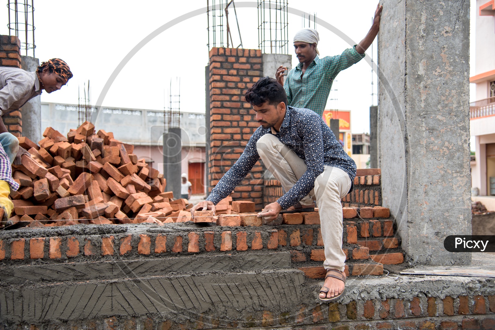 Image of Indian Rural Construction Workers Working Developing a Site By Cement And Bricks In