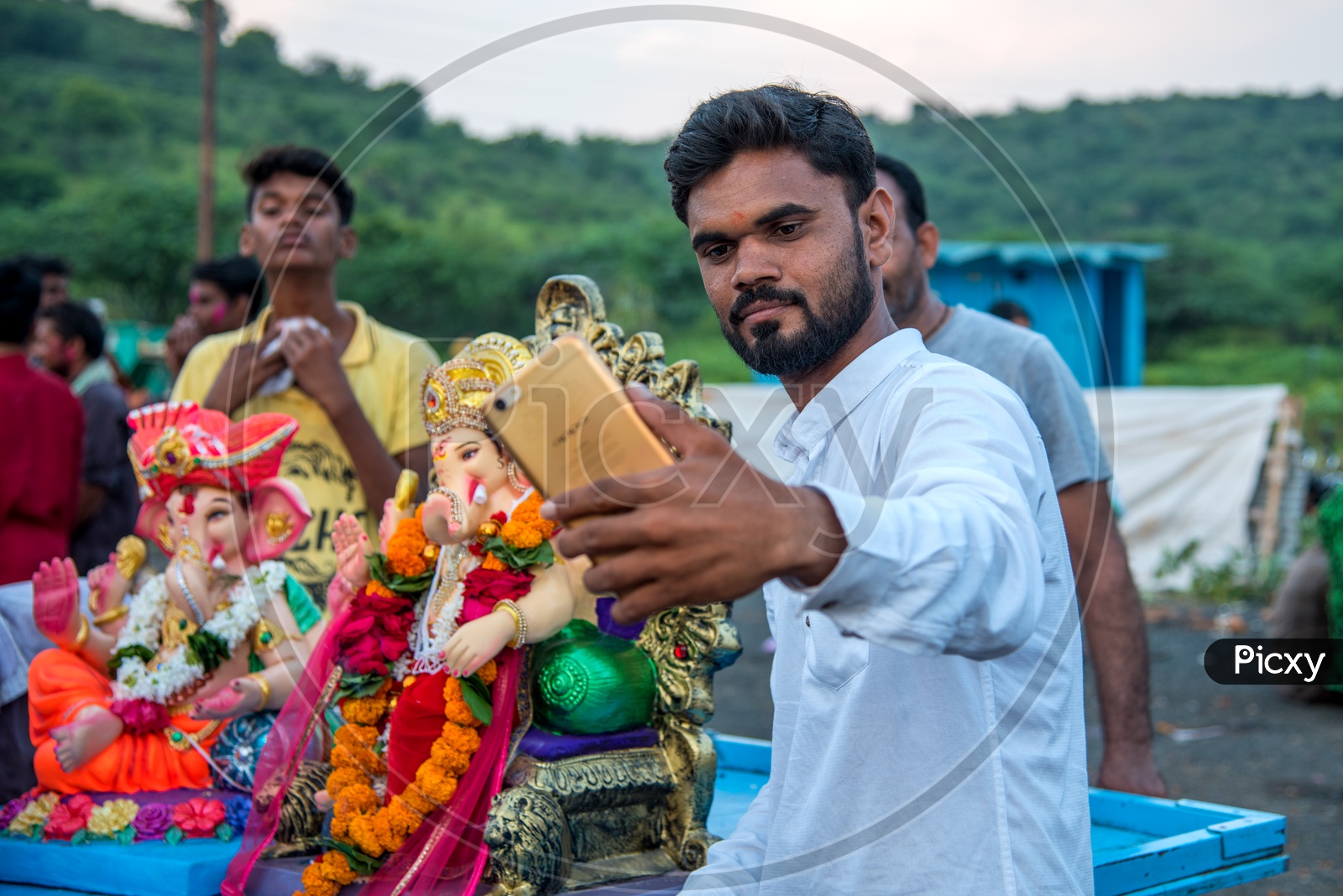 An Indian Young Man Taking A Selfie In Smart Phone With Ganesh Idol During  Ganesh Visarjan Or  Nimarjan