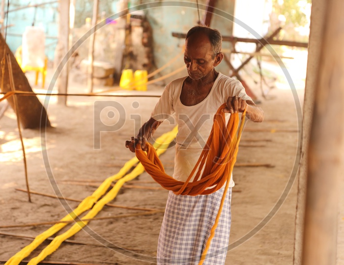 weaver folding threads to make colth