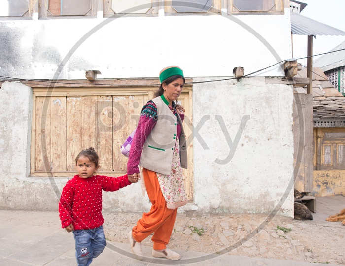 A Mother Walking With Her Child In  The Village Streets Of  Spiti
