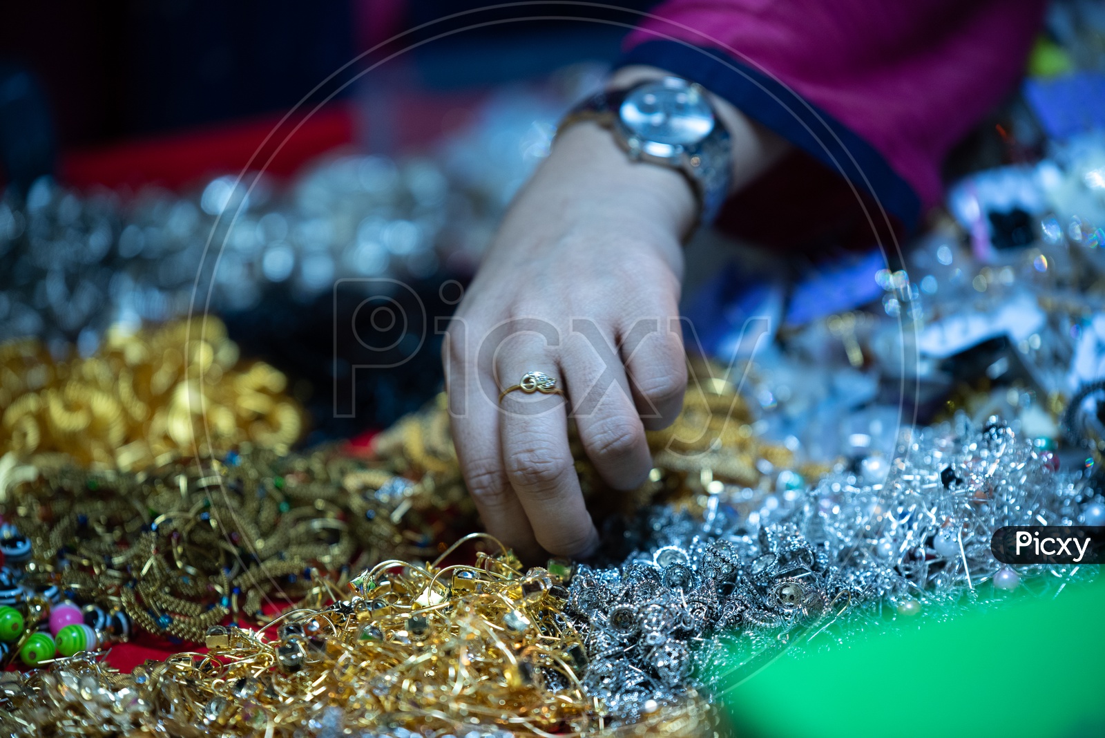 A Woman  Shopping   Ear tops Or  Imitation Jewellery or Fancy Jewellery   Around Charminar Streets  During Ramadan or Ramzan Season