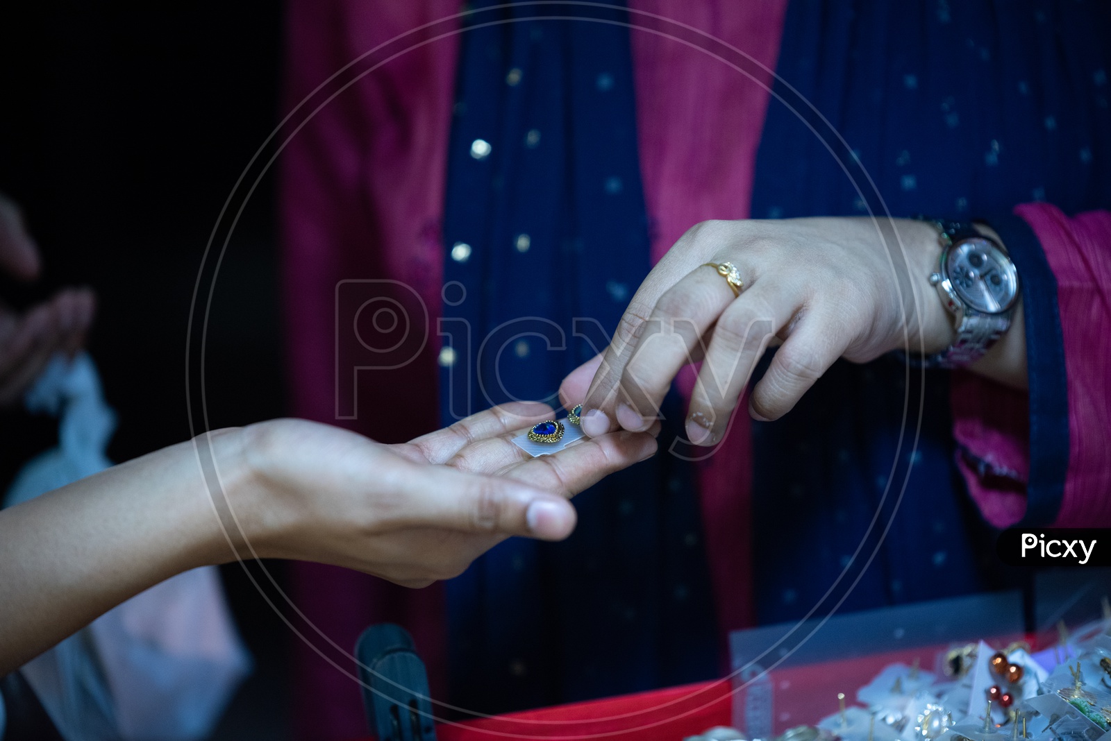 A Woman  Buying or Shopping  Ear Rings or Ear tops  Or Imitation Jewellery  In Vendor Stalls Around Charminar Streets   During Ramadan Or Ramzan Season
