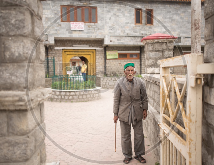 An Old Man In His Traditional Attire At a Temple In Spiti Valley