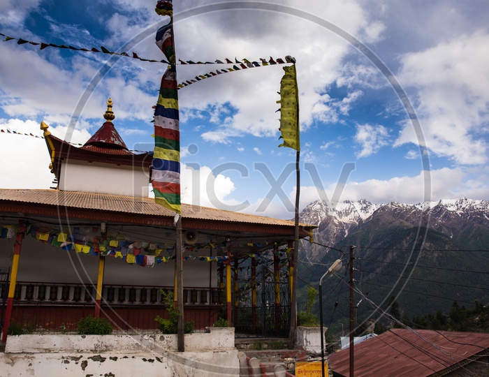 Buddhist Temple Shrines With Snow Capped Mountains In The Background