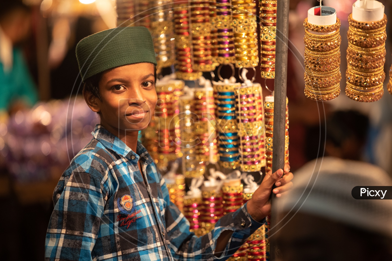 A Boy Working as a  Vendor  in a  Bangles Vending   Stall  Around Charminar  During Ramadan Or Ramzan Season