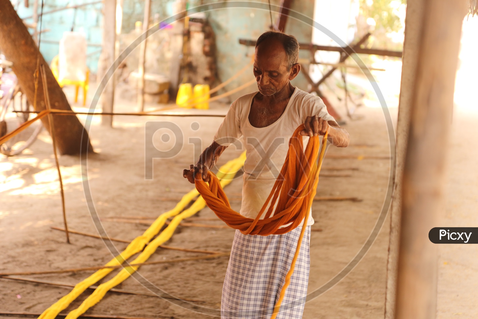 weaver folding threads to make colth
