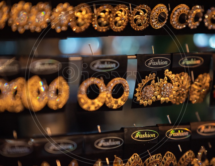 Golden Eartops or  Ear rings Or Imitation Jewellery Hanging  For  Display   In a Vendor Stall  Around Charminar Streets  During  Ramdan Or Ramzan  Season