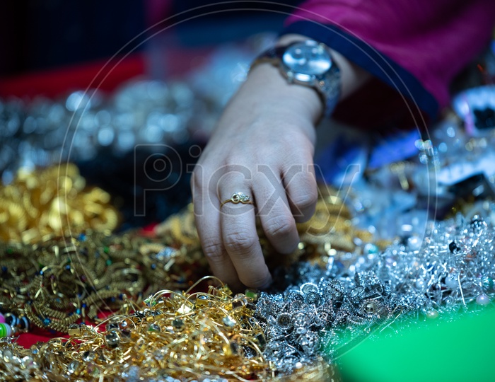A Woman  Shopping   Ear tops Or  Imitation Jewellery or Fancy Jewellery   Around Charminar Streets  During Ramadan or Ramzan Season