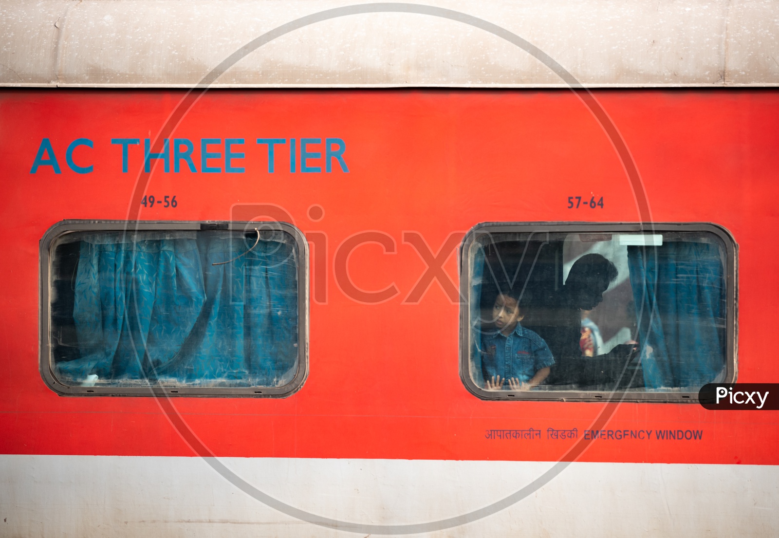 A Kid Or Boy or Child  Looking Through the Window Glass from  a AC Three tier  Bogie of Indian railways Train