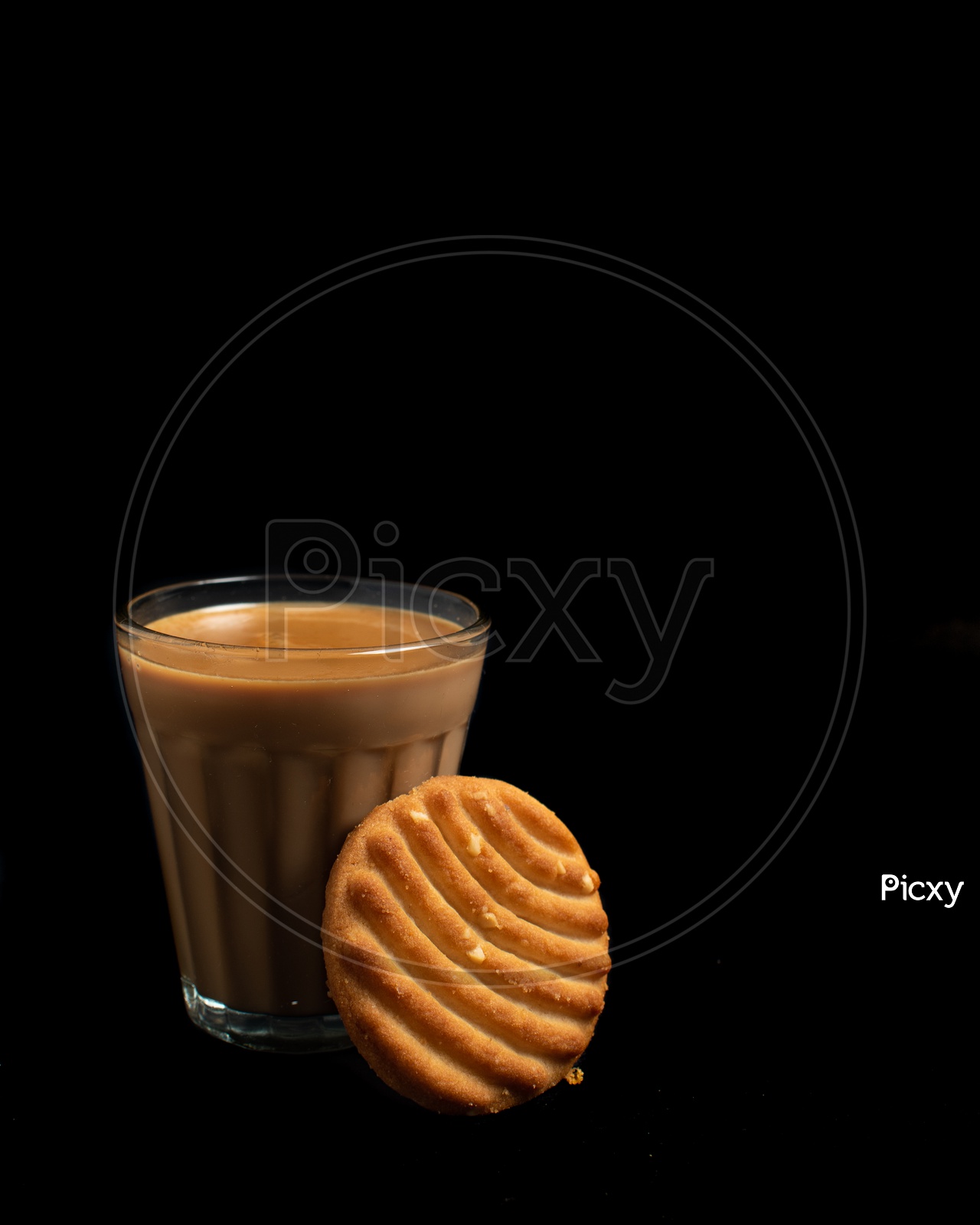 Aromatic beverage Tea/chai   and Good-day biscuits placed on black background.